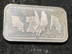lot 04 image: 1 TROY OZ .999 FINE SILVER INTERNATIONAL TRADE UNIT BAR