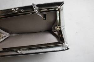 lot 9 image: Metallic Silver Clutch Bag with Chain Strap
