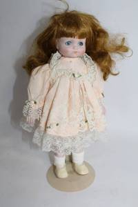 lot 9 image: Vintage Porcelain Doll with Blonde Hair and Lace Dress
