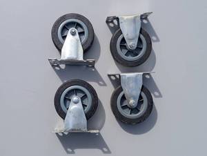 lot 35 image: Set of four mini casters non-swivel four-hole approximate 2 to 3 in