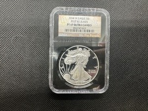 lot 27 image: 2014-W  First Releases Proof 1  Oz. Silver American Eagle NGC Ultra Cameo PF69  - NGC Price Guide $100