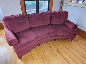lot 86 image: Curved Burgundy Family Sofa
