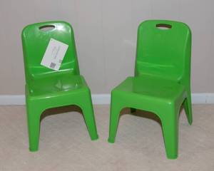 Two Green Plastic Stackable Children's Chairs