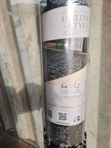 lot 19 image: 8x10 black and grey area rug
