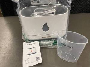 lot 32 image: Unopened Electric Aroma Diffuser with Measuring Cup and Instructions