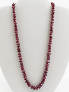 lot 12 image: Natural Facted Ruby Gold Tone Base Metal Bead Necklace. Estimated Replacement Value $600