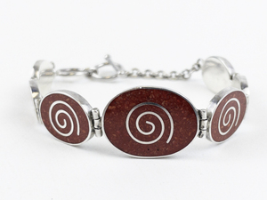 lot 22 image: Red Coral Spiral Sterling Silver Link Bracelet.