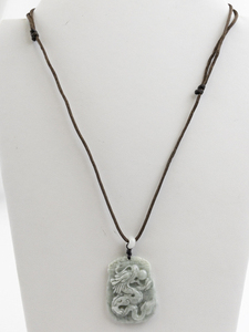 lot 49 image: Jadite Jade Or Adventurine Carved Dragon Leather Cord Necklace .