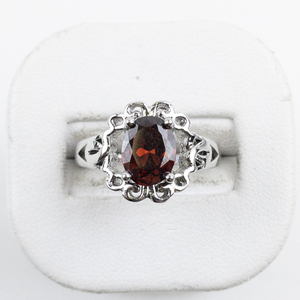 lot 78 image: Oval Cut Red Stone Silver Tone Base Metal Ring. Size 7.75 - 8.
