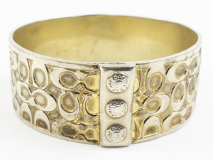 lot 149 image: Coach  Wide Quilted Signature Gold Tone Base Metal Bangle Bracelet.