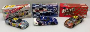 lot 47 image: Three Vintage 124 Scale NASCAR Die Cast Jeff Gordon Cars 1 Bank (NIB)