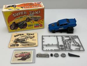 lot 92 image: Vintage 1970 Monogram  SUPER TAXI Snap Tite Model Kit (In Original Box) Plus Bonus Trading Card In Protective Sleeve