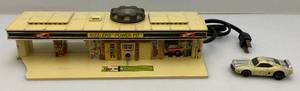lot 261 image: 1970 SIZZLERS Power Pit (Piece Broken Off Missing Pieces & One Car Present)