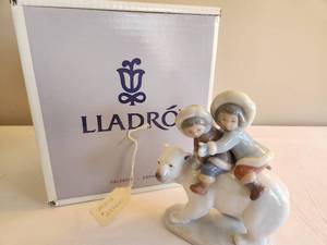 lot 44 image: Lladro Children on Polar Bear Figurine