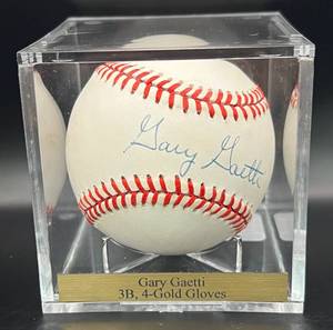 lot 51 image: Garry Gaetti (Minnesota Twins 3B) Signed Baseball Rawlings OALB Brown Ball w cube and plaque