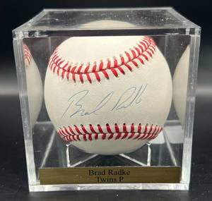 lot 92 image: Brad Radke (Minnesota Twins Pitcher) Signed Rawlings OALB Budig Baseball w cube and plaque