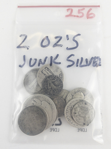 lot 256 image: 1 bag of over 2 ounces of junk silver coins worn dates, drilled, bent, dinged etc.