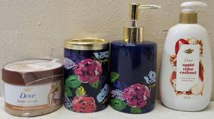 lot 25 image: For the Bathroom - (1) Midnit Rose Soap Dispenser (1) Midnit Rose Toothbrush Holder (1) Dove Body Scrub - Brown Sugar & Coconut Butter (1) Dove Apple Cider Caramel Hand Wash