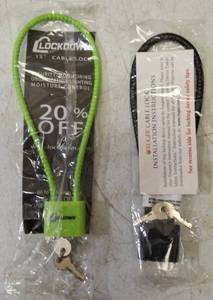 lot 53 image: Bike Locks - (1) Lock Down 15 Cable with Keys - Green (1) Ruger Cable Lock with Keys - Black  View Photos