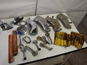 lot 14 image: VINTAGE FORD AND OTHER PARTS, PARTS, PARTS, bumper parts, several window handles, vintage tool cases and other chrome bling