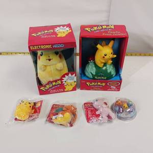 lot 99 image: Vintage POKEMON - PIKACHUs - Talking plush and Talking Door Greeter in original containers.  Extras - all unopened