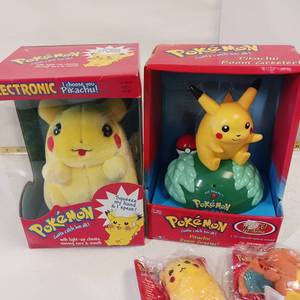 lot 100 image: Vintage POKEMON - PIKACHUs - Talking plush and Talking Door Greeter in original containers.  Extras - all unopened
