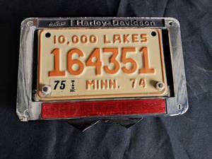 lot 42 image: Harley Davidson License Plate Frame & MN License Plate from 1975