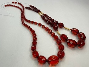 lot 35 image: Two Cherry Amber Plastic Bead Strands