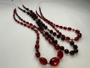 lot 36 image: Three Ruby Red, Cherry Amber  Plastic with Rhinestone Bead Strands