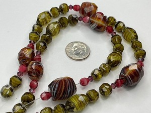 lot 47 image: Faceted Green and Brown Swirl Glass Bead Strand