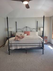 Elegant Black Metal Four Poster King Bed Frame and Elegant Beige and Pink King Bedding Set with Accents