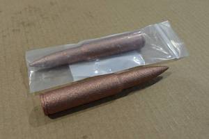 lot 220 image: 2 Copper Novelty 50 BMG Rounds