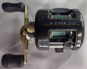 lot 6 image: Bass Pro Shops Extreme ETXR 10H Baitcasting Reel, shows some wear, works very well