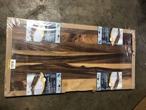 lot 32 image: Lot of Hampton Bay 4 ft. L x 25 in. D Finished Saman Solid Wood Butcher Block Standard Countertop in with Live Edge  Customer Returns See Pictures