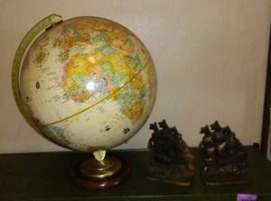 lot 943 image: Vintage Replogle Globe and Cast Iron bookends.