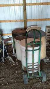lot 828 image: Barrel Cart With (4) Barrels, Rubbermaid Trash can and More.