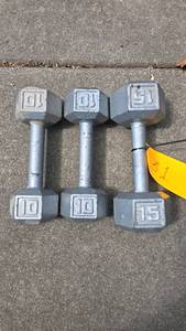 lot 31 image: Hex Dumbbells Set, 10 lbs and 15 lbs, Gray Cast Iron, set of 3 dumbbells (2 x 10 lbs, 1 x 15 lbs), textured metal grip handles.