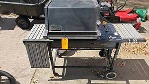 lot 38 image: Weber Gas Grill with 3 burners, propane fuel, crossover ignition system, side shelves, wheels for mobility, comes with a propane tank.