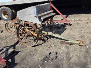 lot 9 image: Vintage Seed Planter Implements with Metal Wheels