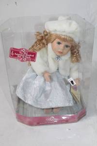 lot 66 image: Animated Musical Doll with Curly Hair and Winter Outfit