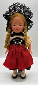 lot 88 image: Vintage Wind-Up Doll with Traditional Dress and Key