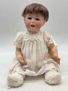 lot 89 image: Antique 1914 Jutta Bisque Head Doll That Cries, with Lace Dress and Knit Booties