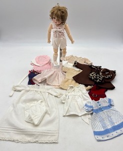 lot 117 image: Collectible Vintage Porcelain Doll with Assorted Clothing by Marlene Gaige
