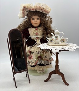 lot 126 image: Vintage Porcelain Doll with Tea Set, Mirror, and Table