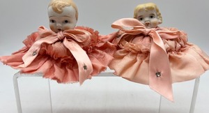 lot 132 image: Pair of Vintage Porcelain Doll Head Pincushions with Pink Ribbon Dresses