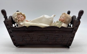 lot 145 image: Vintage Wooden Baby Cradle with Two Porcelain Bye Lo Bisque Dolls and One Made in Japan Cloth Doll