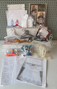 lot 226 image: Assorted Doll Dress Patterns with Variety of Miniature Hangers