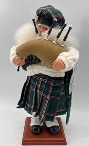 lot 240 image: Handcrafted Scottish Santa Claus Figurine with Bagpipes
