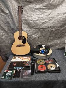 lot 85 image: First Act Acoustic Guitar with Headphones and Rock CD Collection