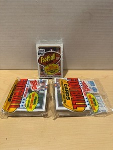lot 276 image: (3) Sealed Topps Football Packs - 1988 Topps with Joe Montana on Top & 2 1989 Topps with John Elway on Top LK